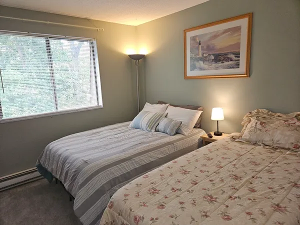 a bedroom with a bed furniture and a window