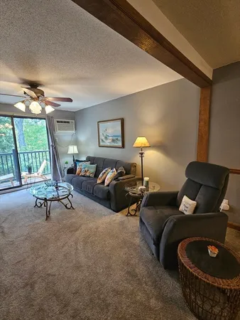 a living room with furniture and a lamp