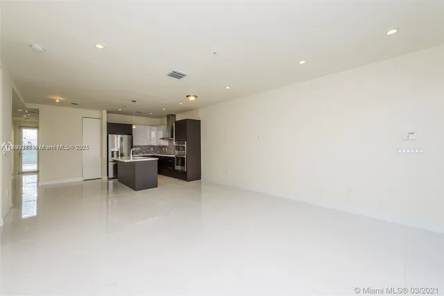 a kitchen with a refrigerator and a sink