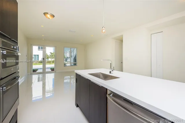 a kitchen with a sink and refrigerator