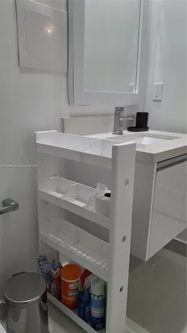 a bathroom with a sink toilet and mirror