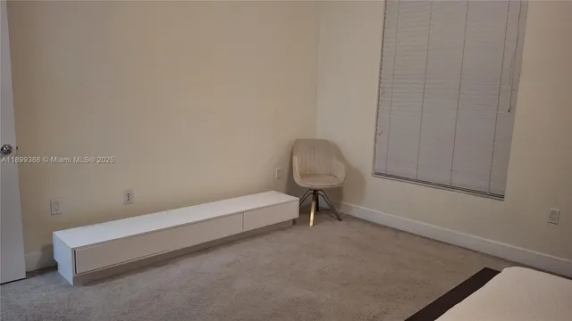 a view of a room with a bench and a window