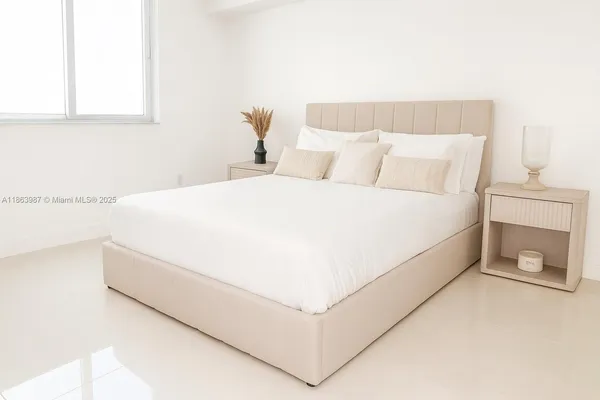 a close up of a bed in a white room