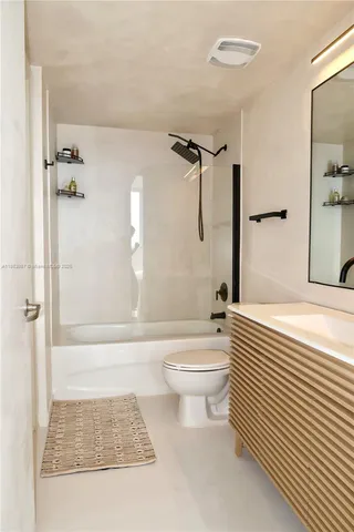 a bathroom with a toilet a sink and shower