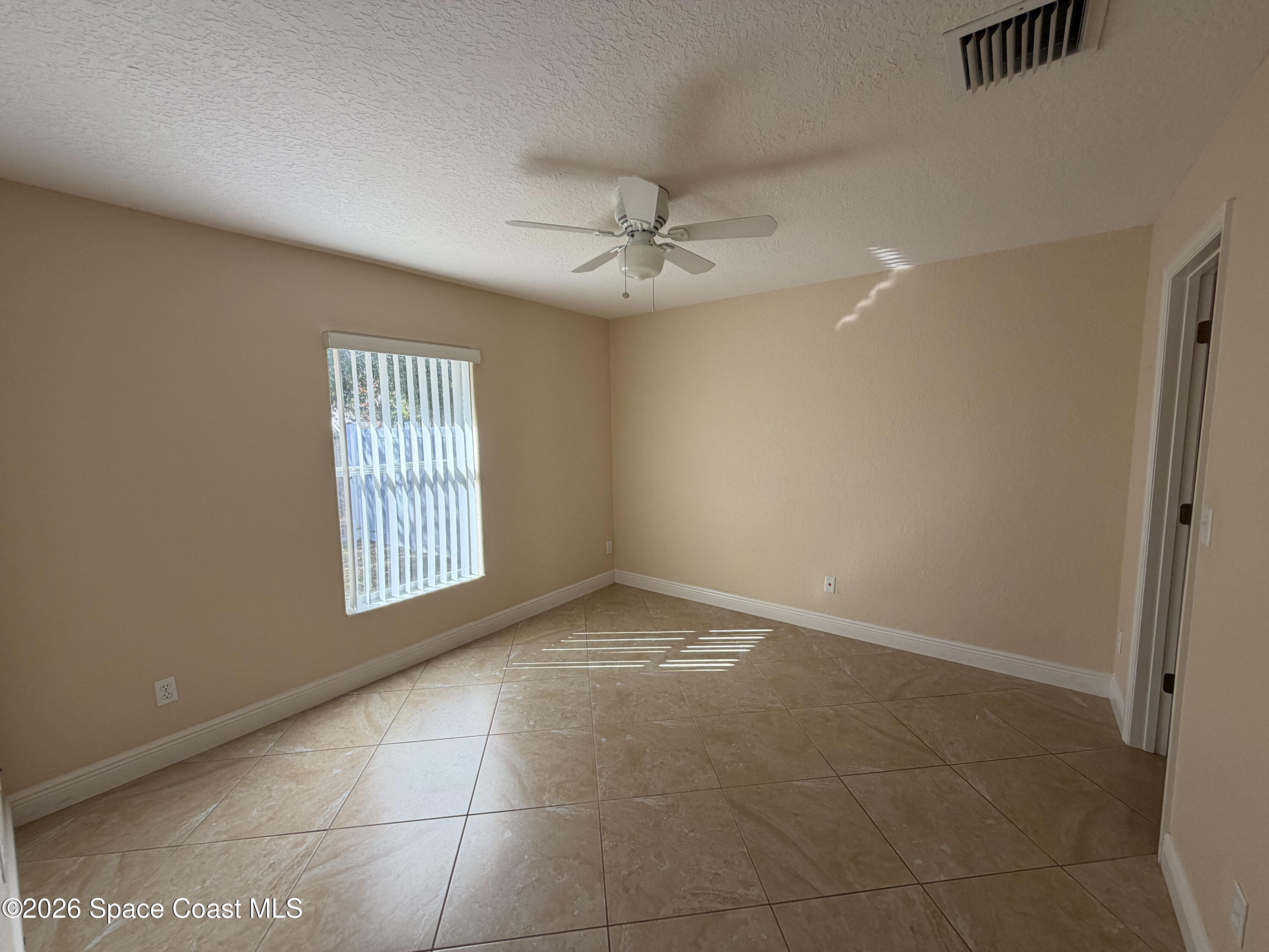 1904 Fletcher Street Melbourne, FL 32901 - Photo 15 of 23 an empty room with windows and ceiling fan