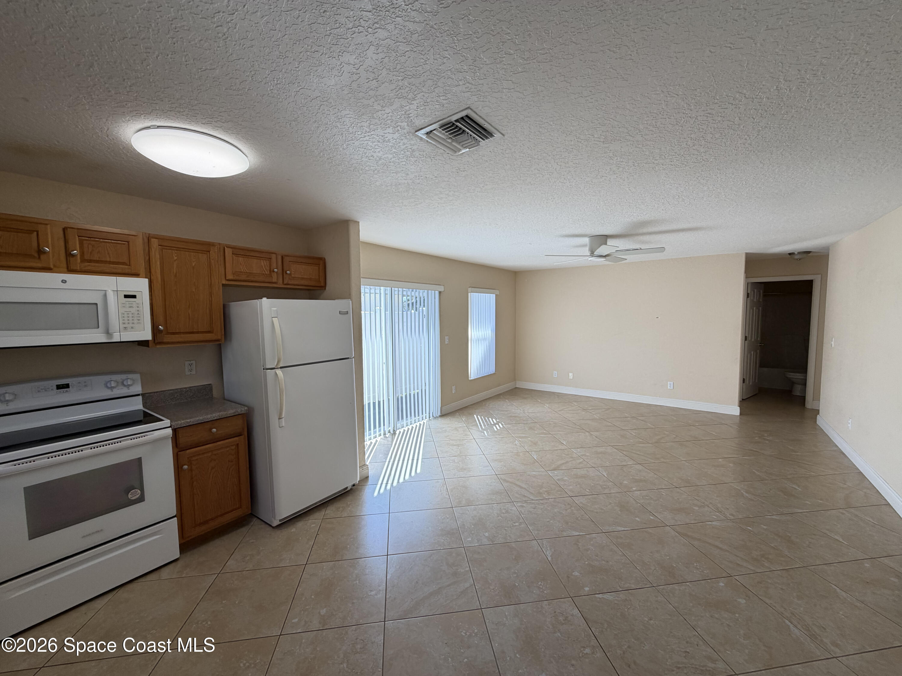 1904 Fletcher Street Melbourne, FL 32901 - Photo 5 of 23 a view of a kitchen with a stove cabinets and a refrigerator