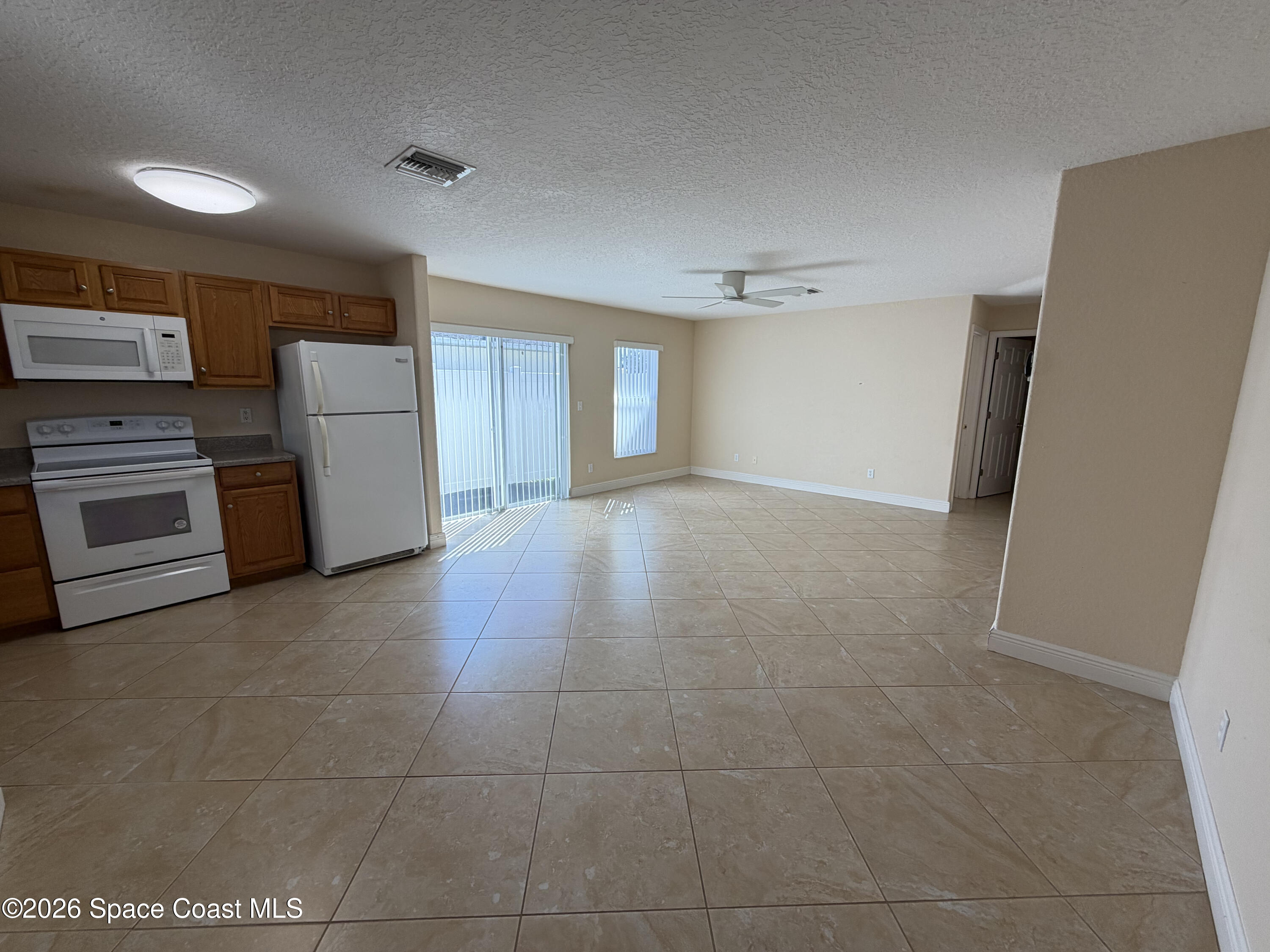 1904 Fletcher Street Melbourne, FL 32901 - Photo 8 of 23 a view of a kitchen with a sink stove refrigerator and cabinets