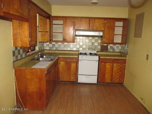 7658 Rambler Road Jacksonville, FL 32244 - Photo 2 of 13 a kitchen with a sink stove and cabinets