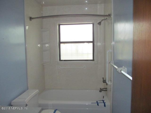 7658 Rambler Road Jacksonville, FL 32244 - Photo 6 of 13 a bathroom with a bathtub and shower
