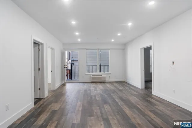 a view of wooden floor and windows in an empty room