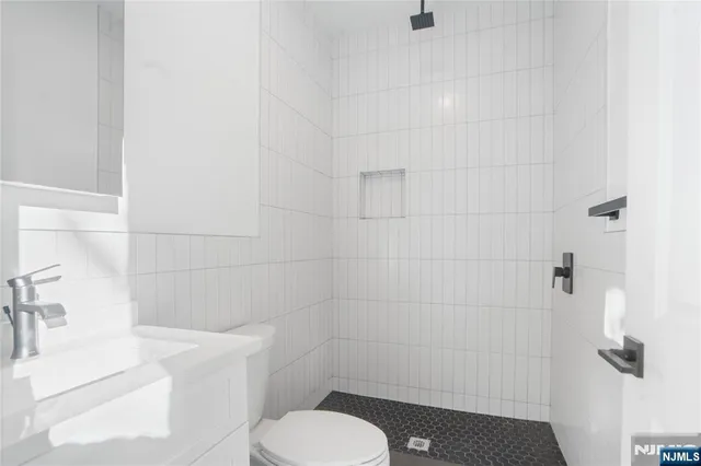 a white toilet sitting next to a bathroom sink