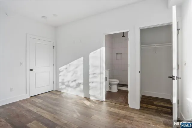 a view of a bathroom with toilet and shower