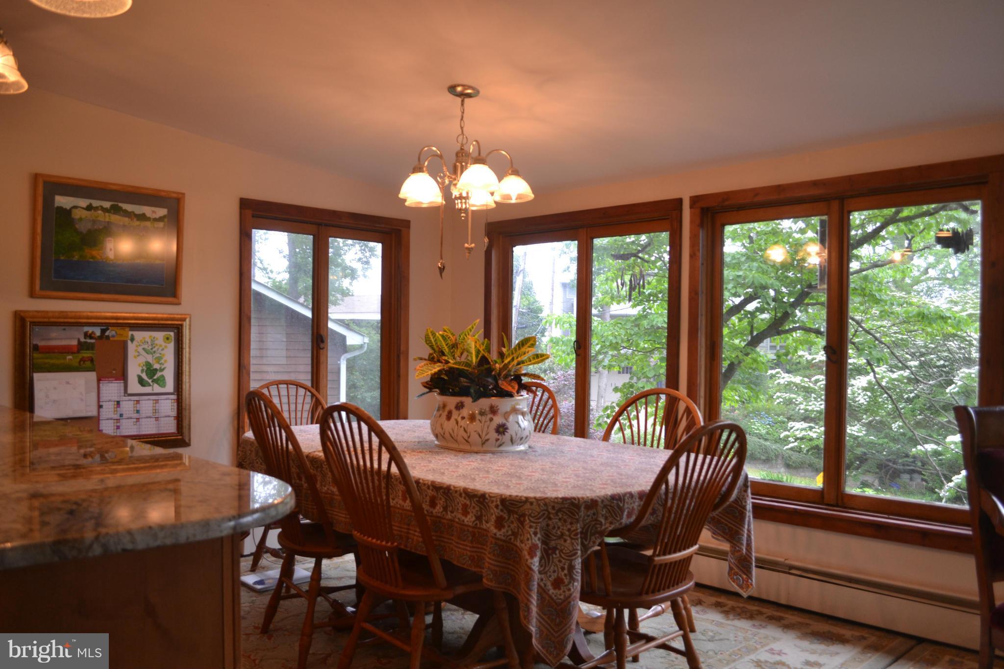 4012 Elder Road Port Republic, MD 20676 - Photo 8 of 25 a view of a dining room with furniture wooden floor and chandelier