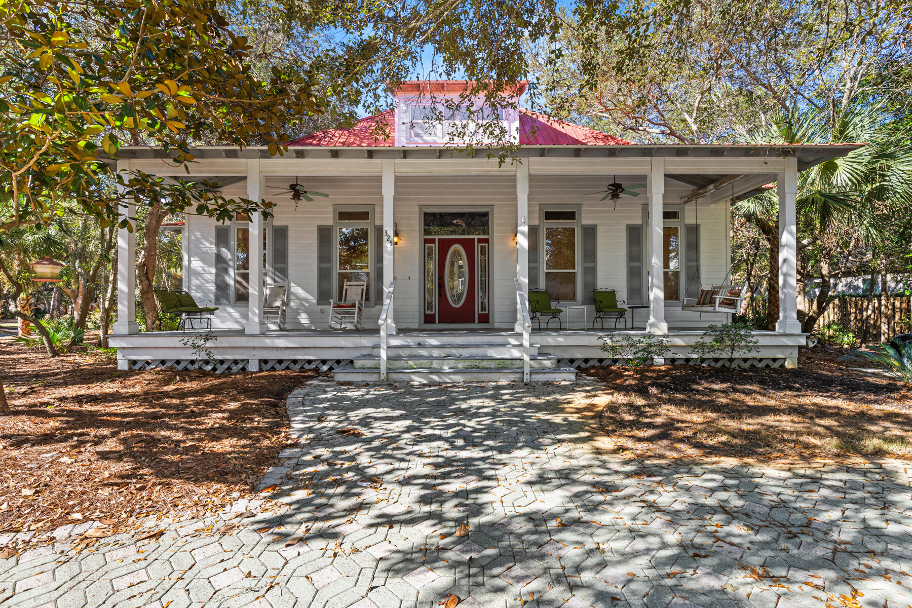 325 Botany Boulevard Santa Rosa Beach, FL 32459 - Photo 1 of 43 a front view of a house with a garden