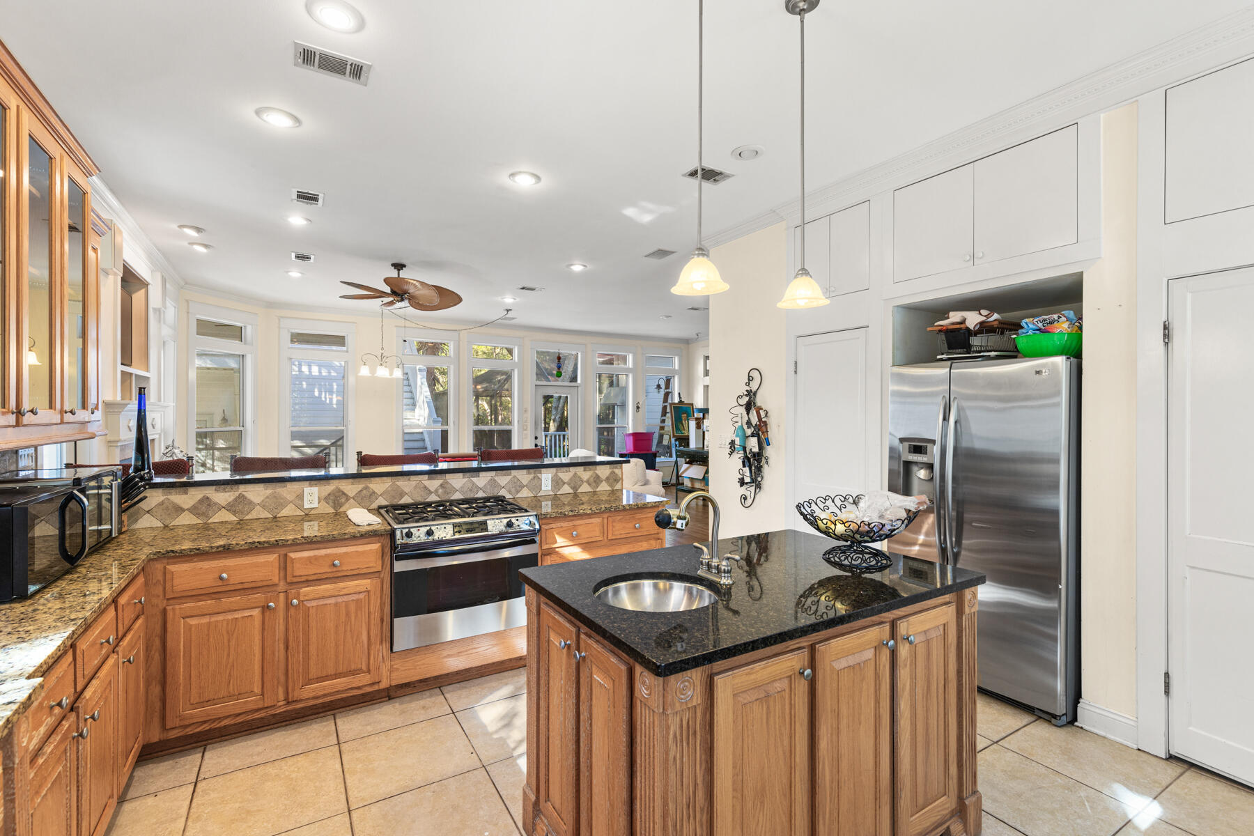 325 Botany Boulevard Santa Rosa Beach, FL 32459 - Photo 5 of 43 a kitchen with stainless steel appliances granite countertop a stove and a refrigerator