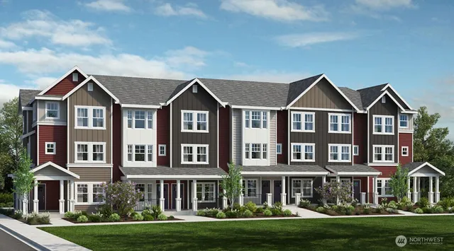 a front view of residential houses with yard and green space