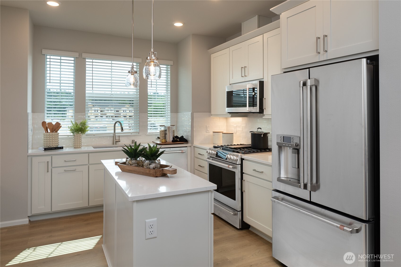 19288 Northeast 69th Circle, Unit 103 Redmond, WA 98052 - Photo 3 of 11 a kitchen with stainless steel appliances a refrigerator sink and cabinets