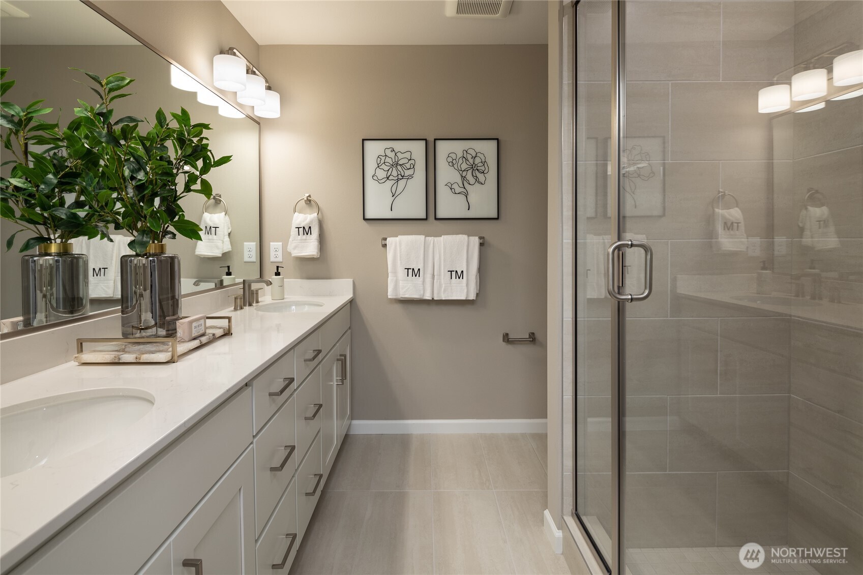 19288 Northeast 69th Circle, Unit 103 Redmond, WA 98052 - Photo 6 of 11 a bathroom with a double vanity sink mirror and shower