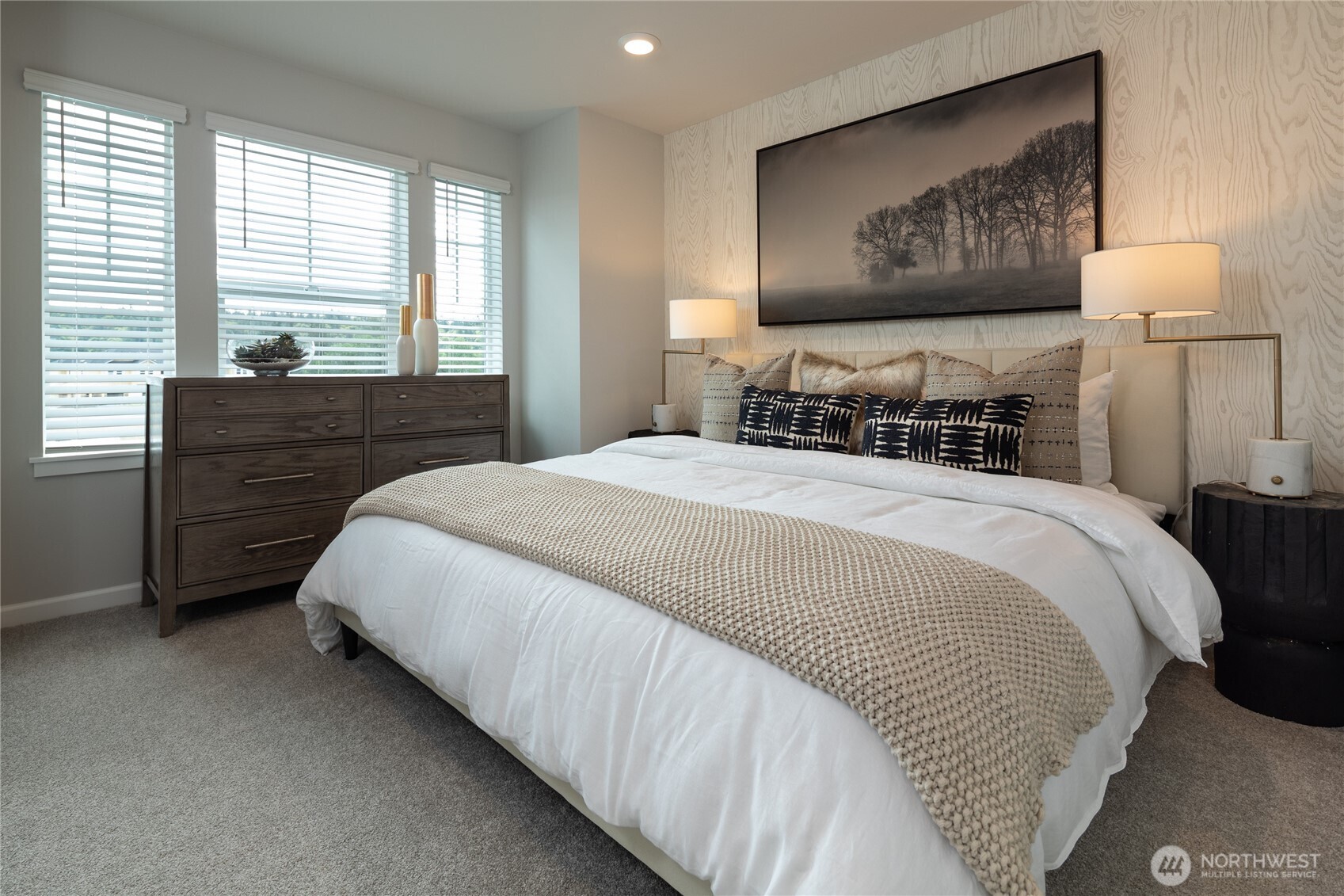 19288 Northeast 69th Circle, Unit 103 Redmond, WA 98052 - Photo 9 of 11 a bedroom with a bed and a painting on the wall