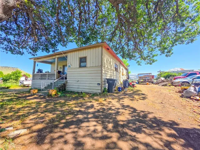 a backyard of a house with table and chairs
