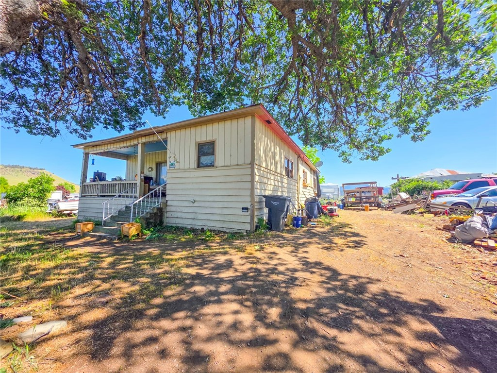 a backyard of a house with table and chairs
