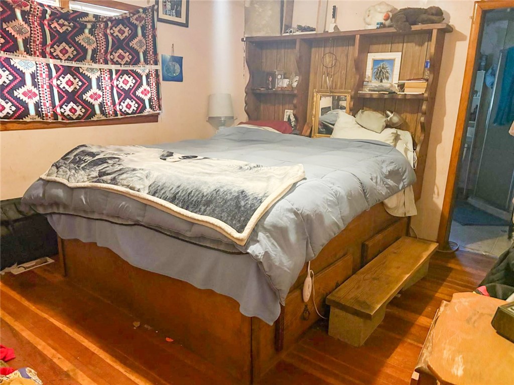 324 Henley Hornbrook Road Hornbrook, CA 96044 - Photo 6 of 9 a bedroom with a bed and wooden floor