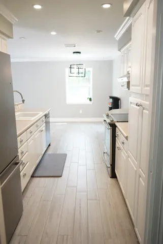 a kitchen with granite countertop a stove and a refrigerator