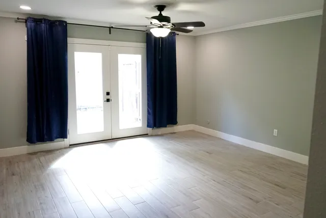 wooden floor in an empty room with a window