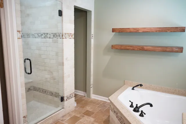 a bathroom with a tub and shower