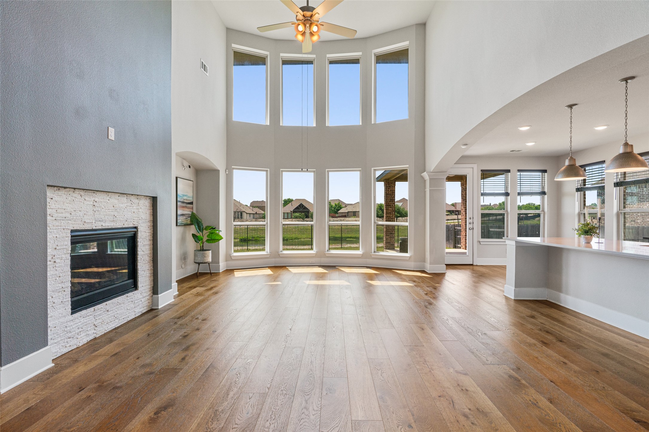 108 Rio Vista Drive Georgetown, TX 78626 - Photo 10 of 40 an empty room with wooden floor fireplace and windows