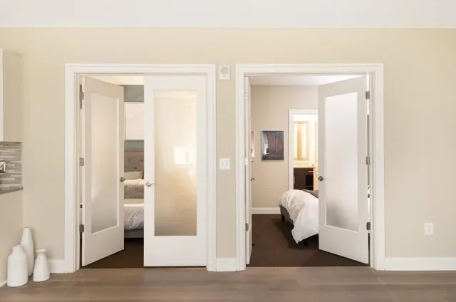 a living room with furniture and a wooden floor