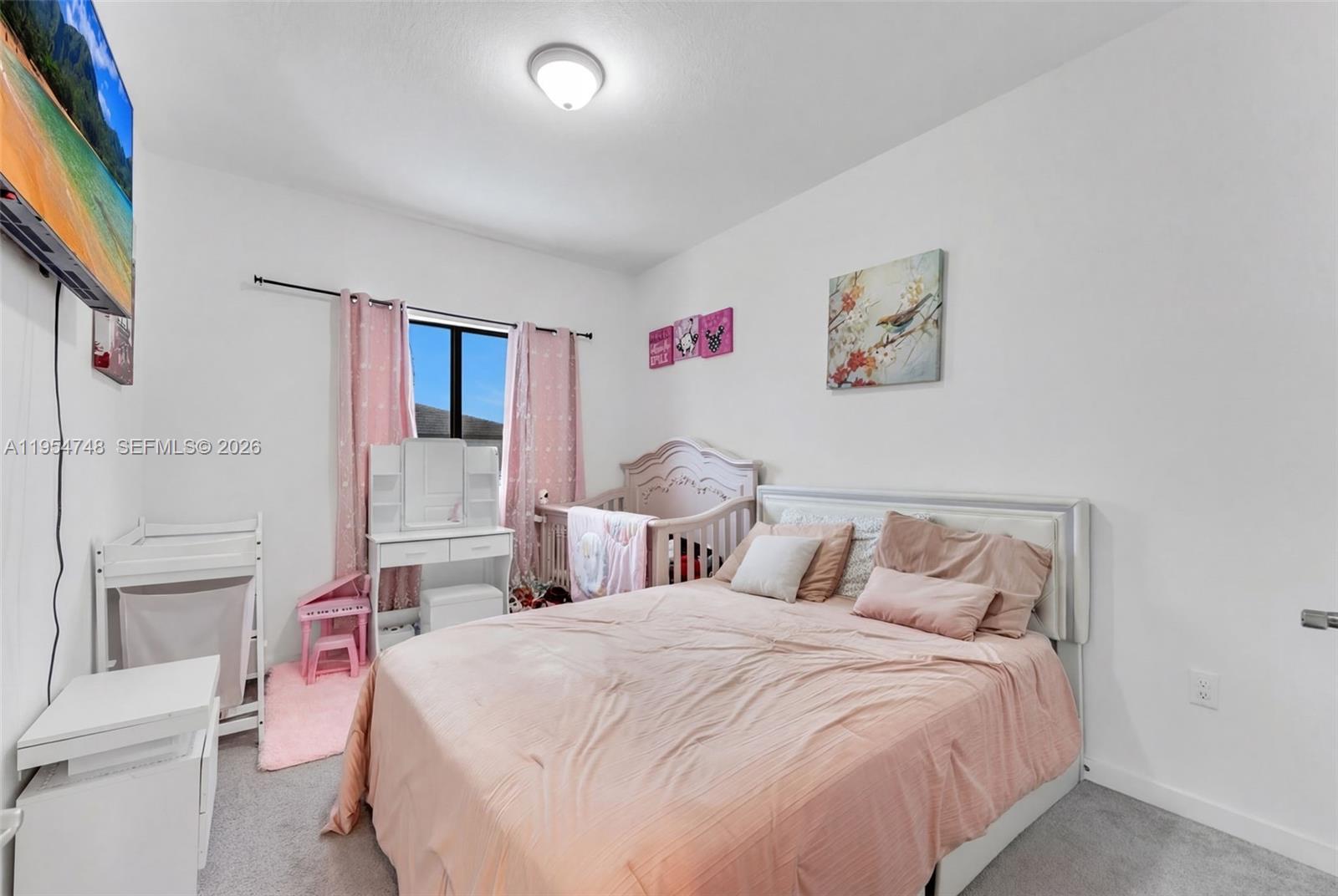 13356 Southwest 250th Street Homestead, FL 33032 - Photo 11 of 21 a bedroom with a bed and a flat screen tv