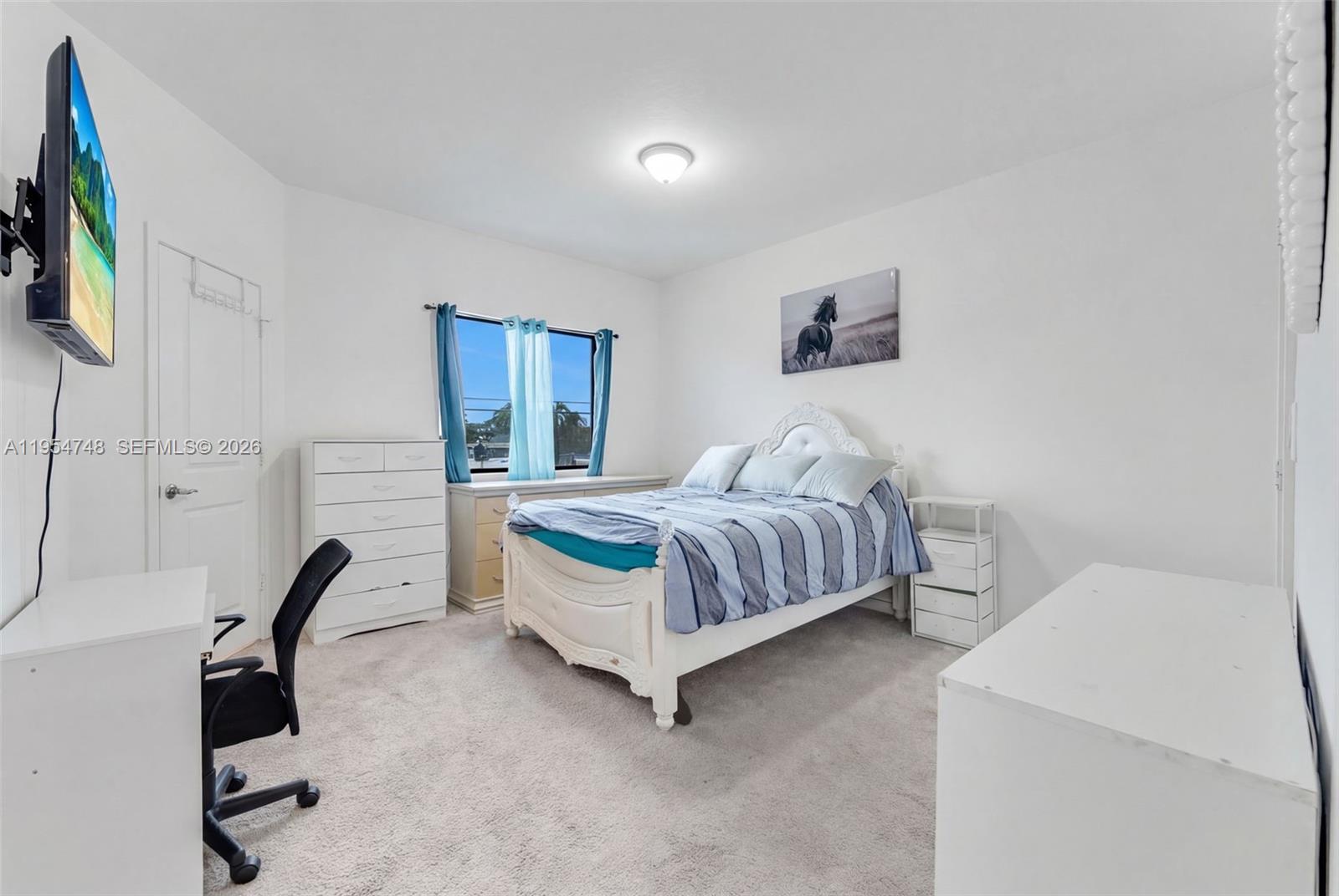 13356 Southwest 250th Street Homestead, FL 33032 - Photo 9 of 21 a bedroom with a bed and a chair