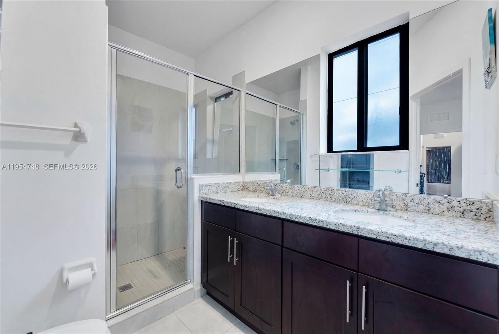 13356 Southwest 250th Street Homestead, FL 33032 - Photo 10 of 21 a bathroom with a granite countertop sink a mirror and a shower