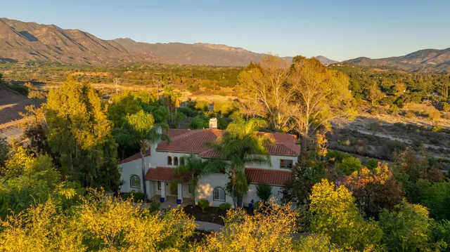 a view of a town with mountains in the background