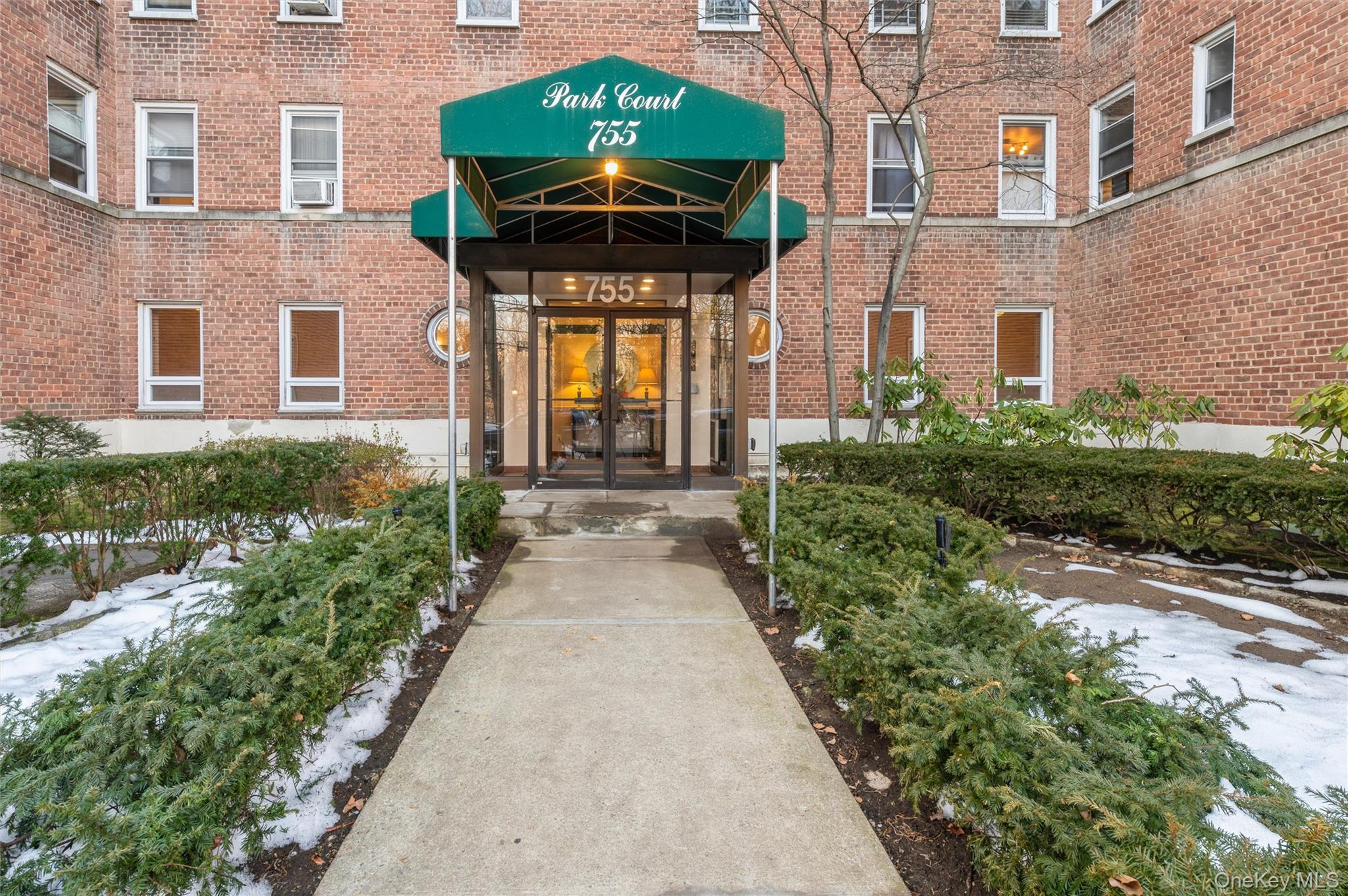 755 Bronx River Road, Unit 1C Bronxville, NY 10708 - Photo 1 of 16 a front view of a house with a yard and potted plants