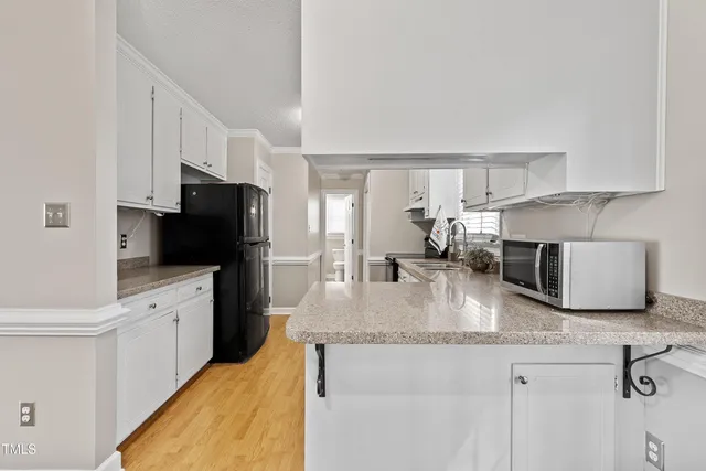 a kitchen with appliances cabinets and a window