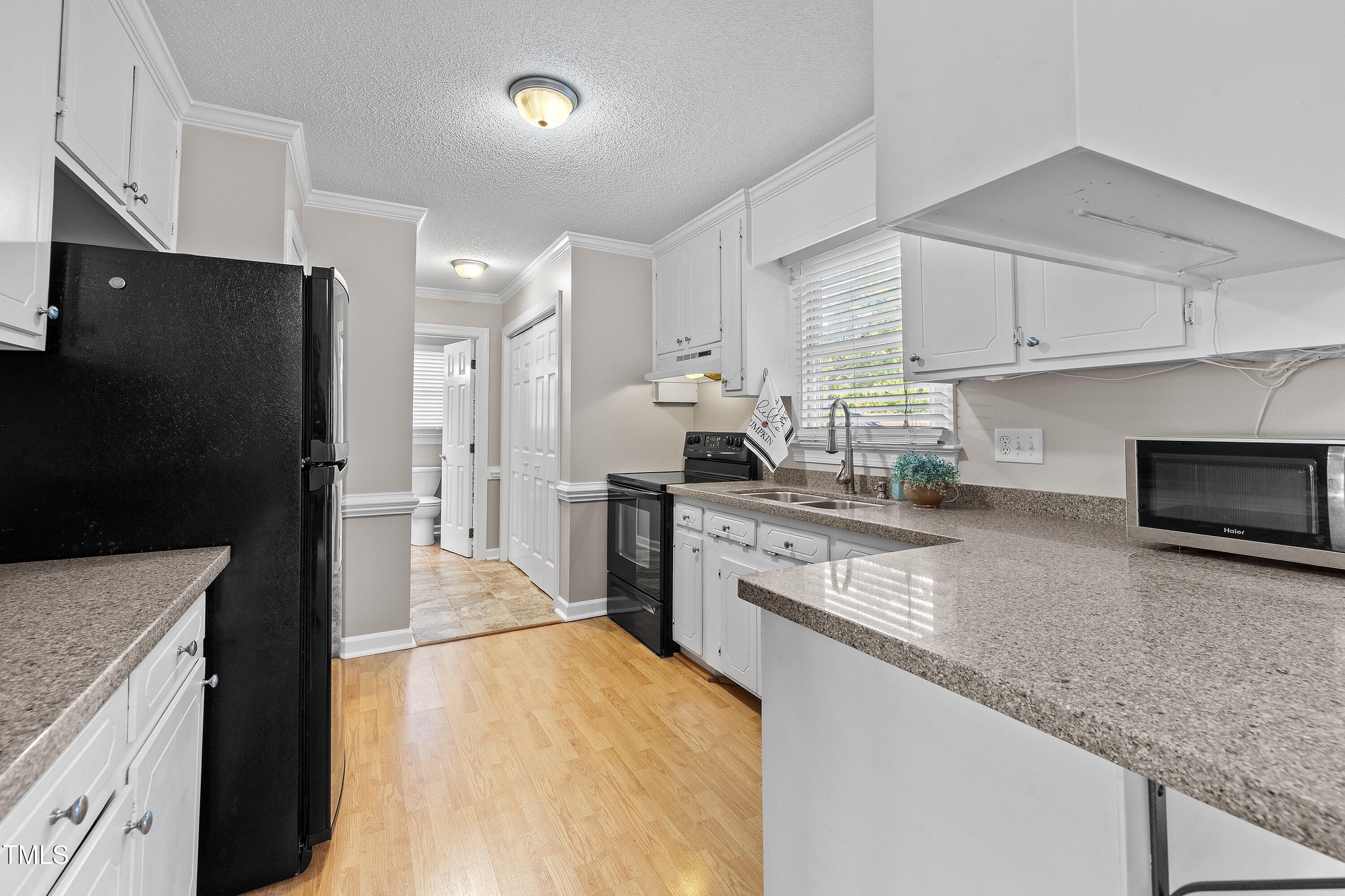 111 Tarpley Way Garner, NC 27529 - Photo 12 of 32 a kitchen with stainless steel appliances granite countertop a refrigerator a stove and a sink