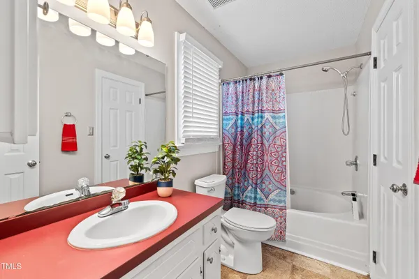 a bathroom with a sink toilet tub and shower