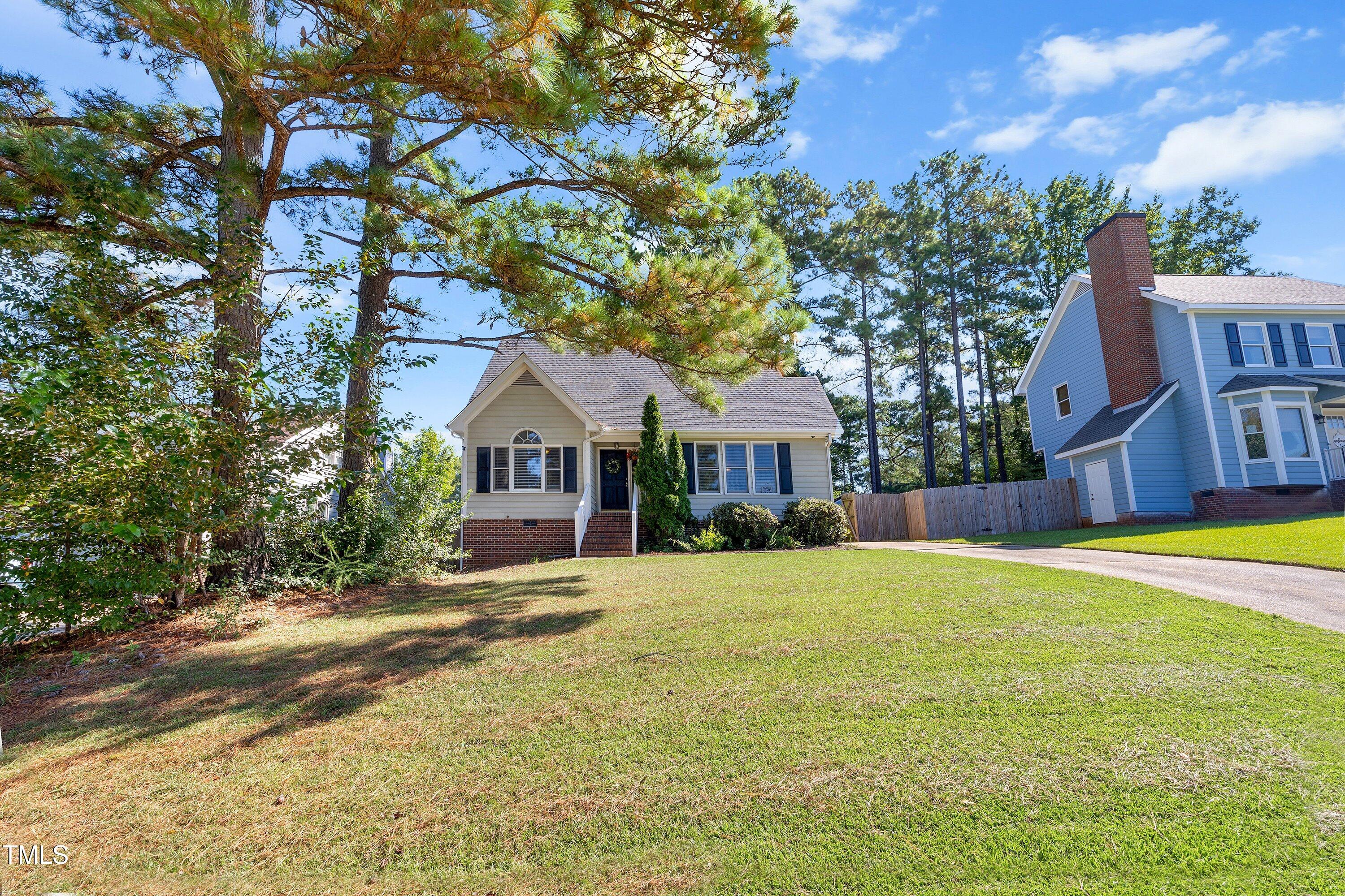 111 Tarpley Way Garner, NC 27529 - Photo 2 of 32 a front view of a house with a yard table and chairs