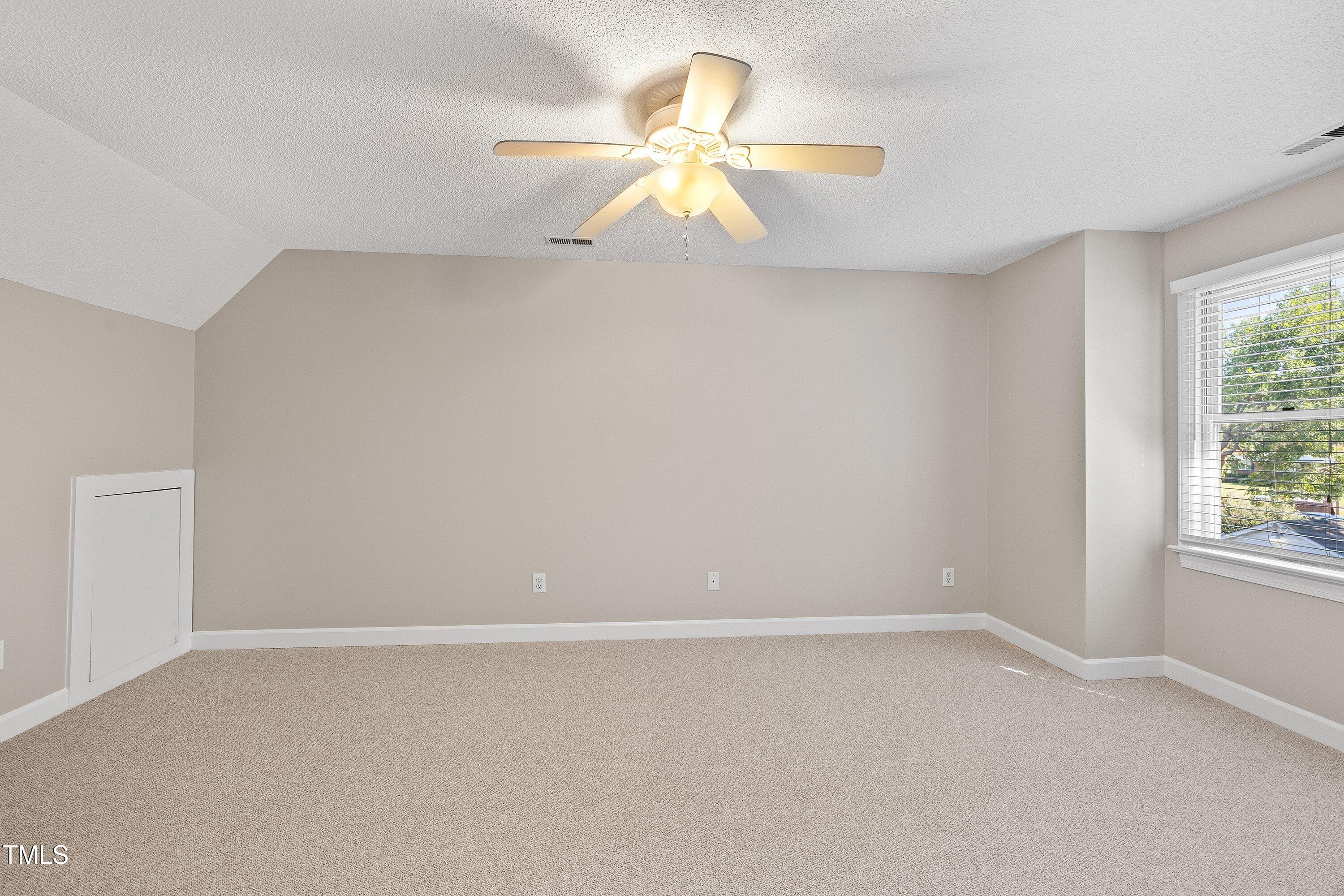 111 Tarpley Way Garner, NC 27529 - Photo 23 of 32 an empty room with a window and a fan