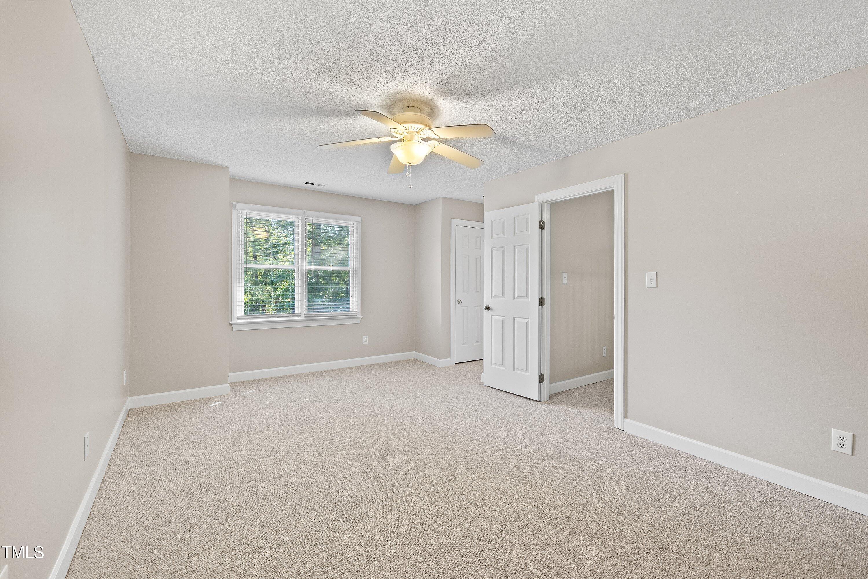 111 Tarpley Way Garner, NC 27529 - Photo 24 of 32 an empty room with a window and a fan