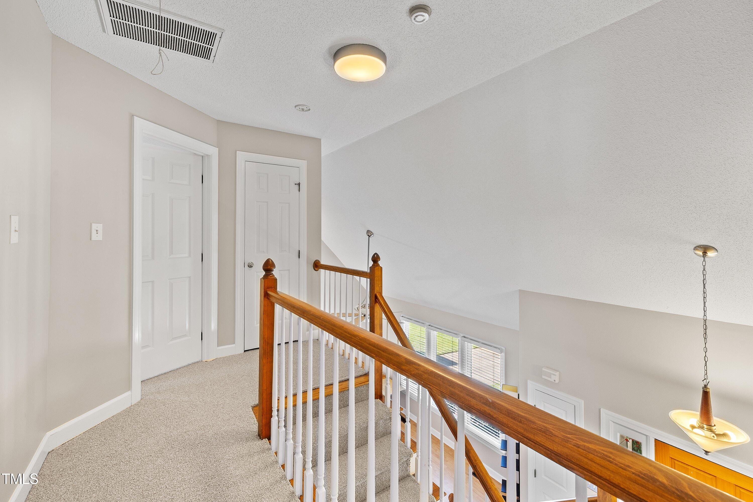 111 Tarpley Way Garner, NC 27529 - Photo 26 of 32 a view of a hallway with wooden floor