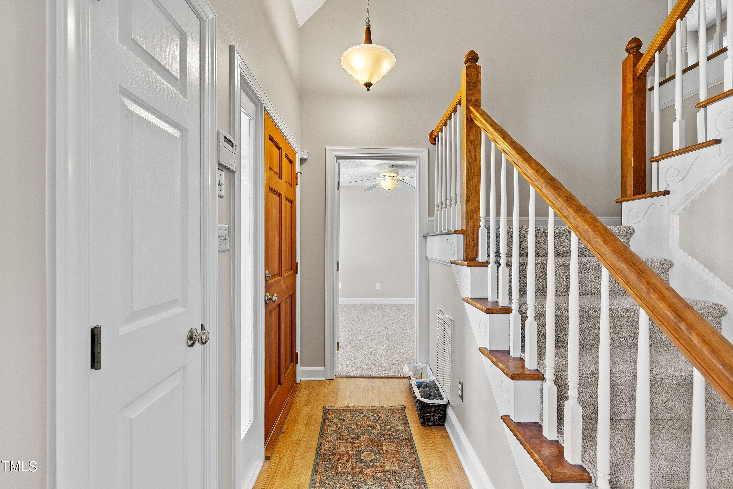111 Tarpley Way Garner, NC 27529 - Photo 5 of 32 a view of a hallway with wooden floor and staircase