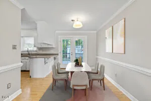 a dining room with furniture and a window