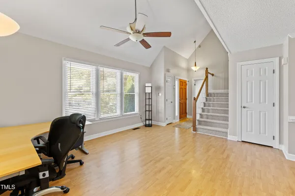 a view of a workspace with furniture and a window