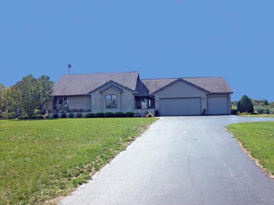 1723 East Spring Creek Road Oregon, IL 61061 - Photo 1 of 6 a front view of a house with a big yard