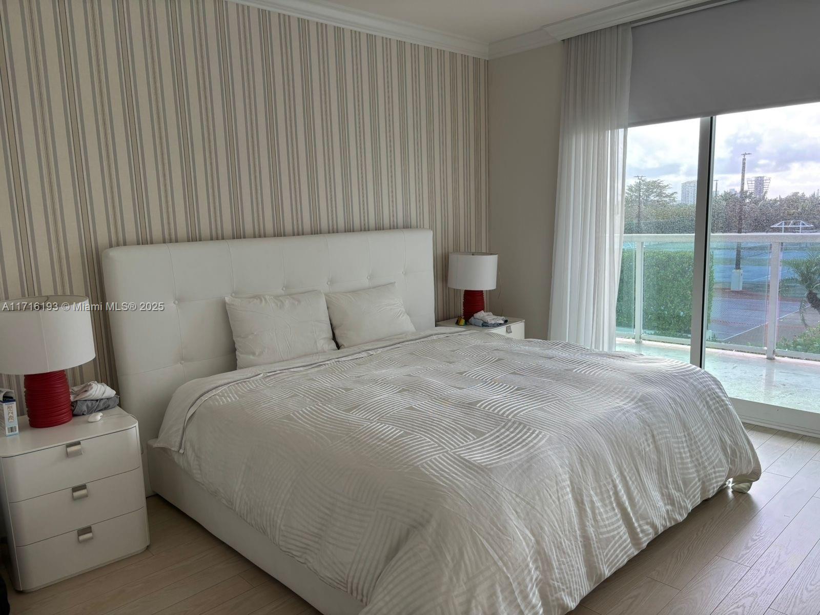 20201 East Country Club Drive, Unit 409 Aventura, FL 33180 - Photo 11 of 12 a bedroom with a bed and a window