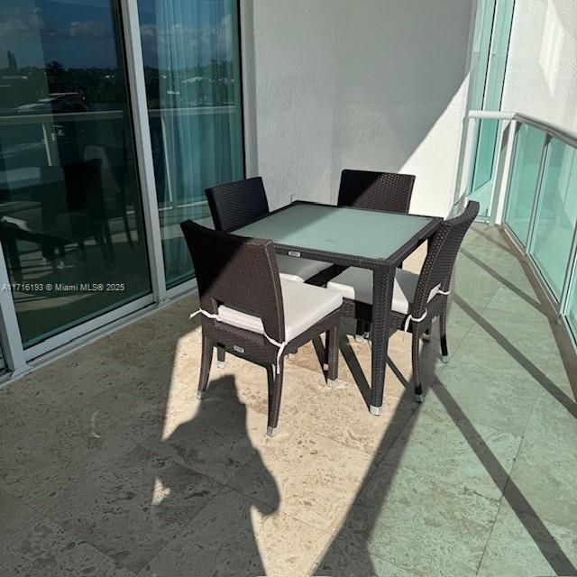 20201 East Country Club Drive, Unit 409 Aventura, FL 33180 - Photo 3 of 12 a view of a dining room with furniture and wooden floor
