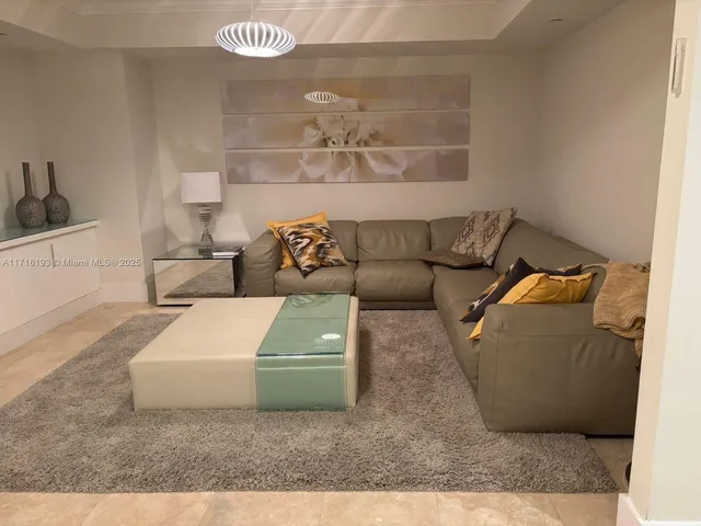 a living room with furniture and a rug